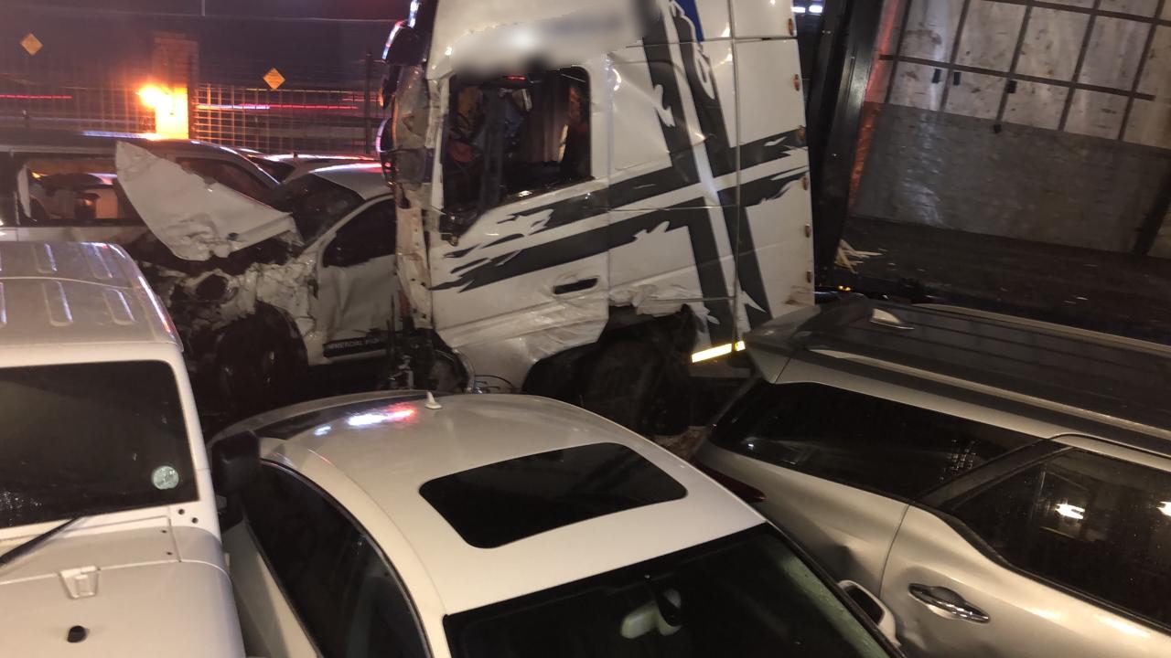 Truck crashes through car park