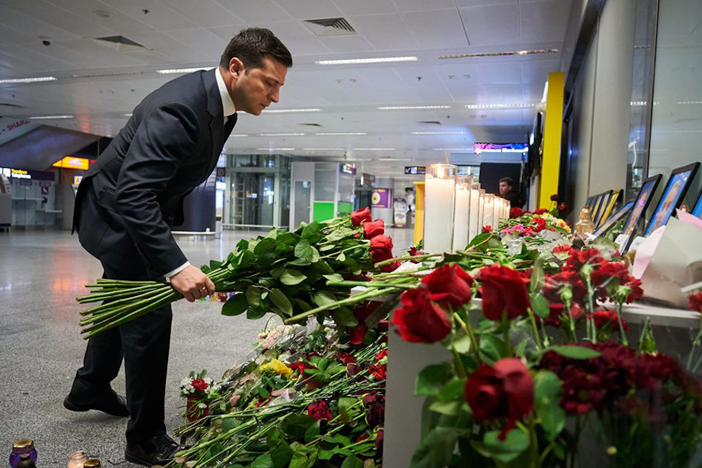 President Volodymyr Zelensky placing flowers at a memorial for the victims of the Ukraine International Airlines Boeing 737-800 crash in the Iranian capital Tehran, at the Boryspil airport outside Kiev