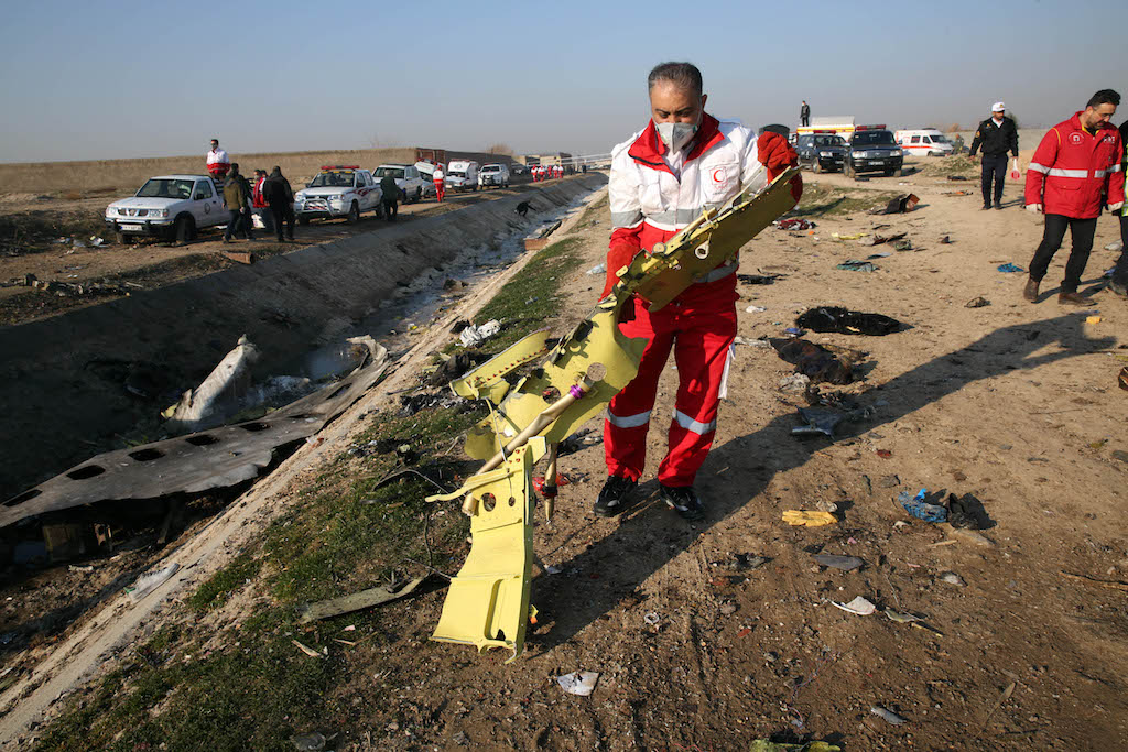 Rescue teams recover debris from a field after a Ukrainian plane carrying 176 passengers crashed near Imam Khomeini airport in the Iranian capital Tehran